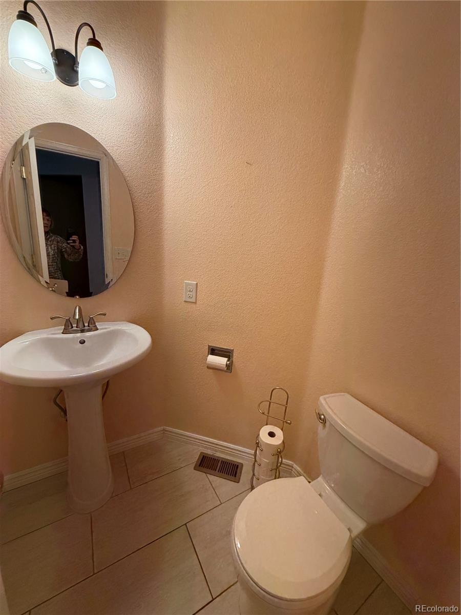 6369 Cole Lane Arvada, CO 80004 - Photo 16 of 21 a bathroom with a sink mirror and toilet