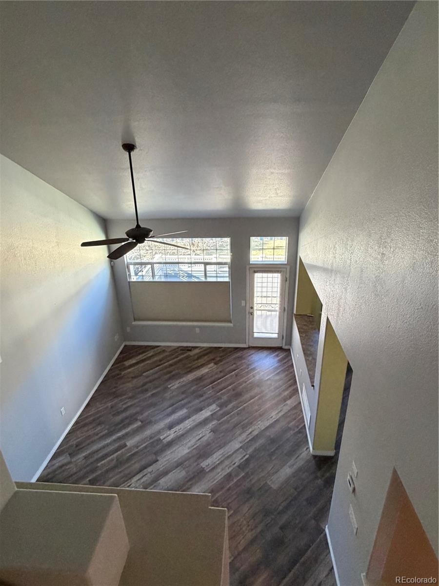 6369 Cole Lane Arvada, CO 80004 - Photo 2 of 21 a view of an empty room with wooden floor and a window