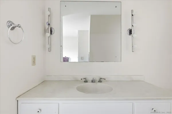 a spacious bedroom with a bed and a window