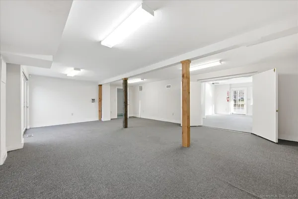 a living room with furniture a large window and table