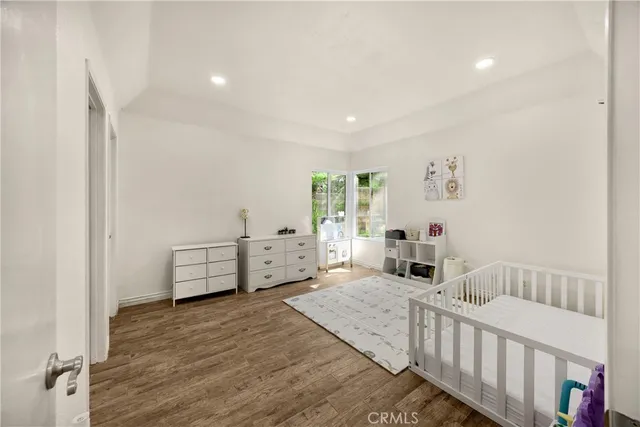 a bedroom with a large bed and a chandelier