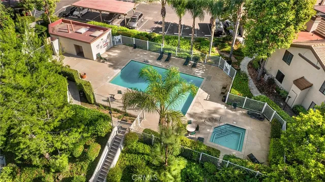 an aerial view of a house with a yard and plants