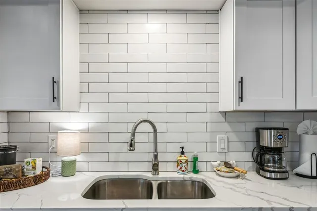 a kitchen with a sink and cabinets