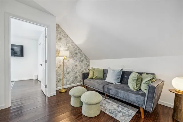 a bedroom with a bed and a wooden floor