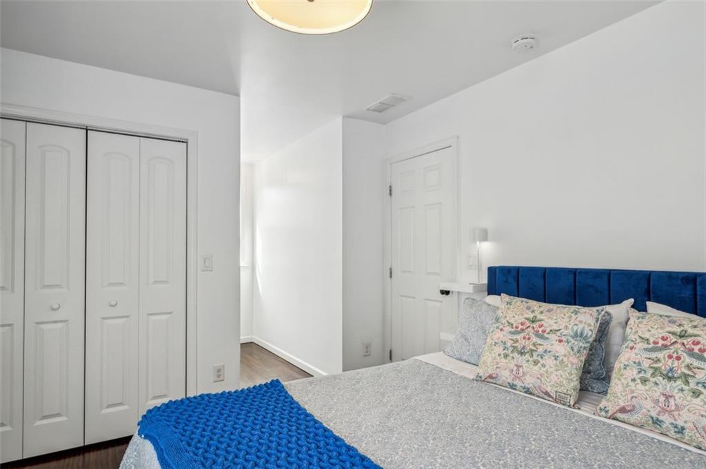21 Willow Woods Road Social Circle, GA 30025 - Photo 22 of 49 a bedroom with a bed and a wooden floor