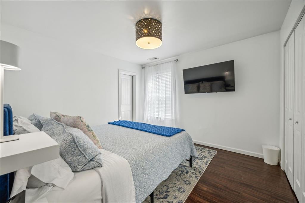 21 Willow Woods Road Social Circle, GA 30025 - Photo 23 of 49 a bedroom with a bed and a flat screen tv