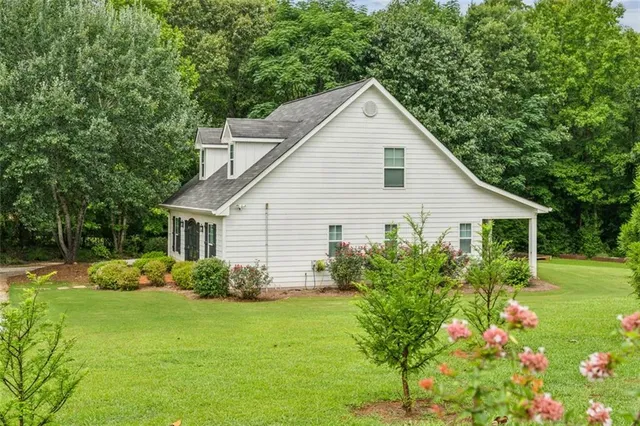 a view of a house with garden and yard