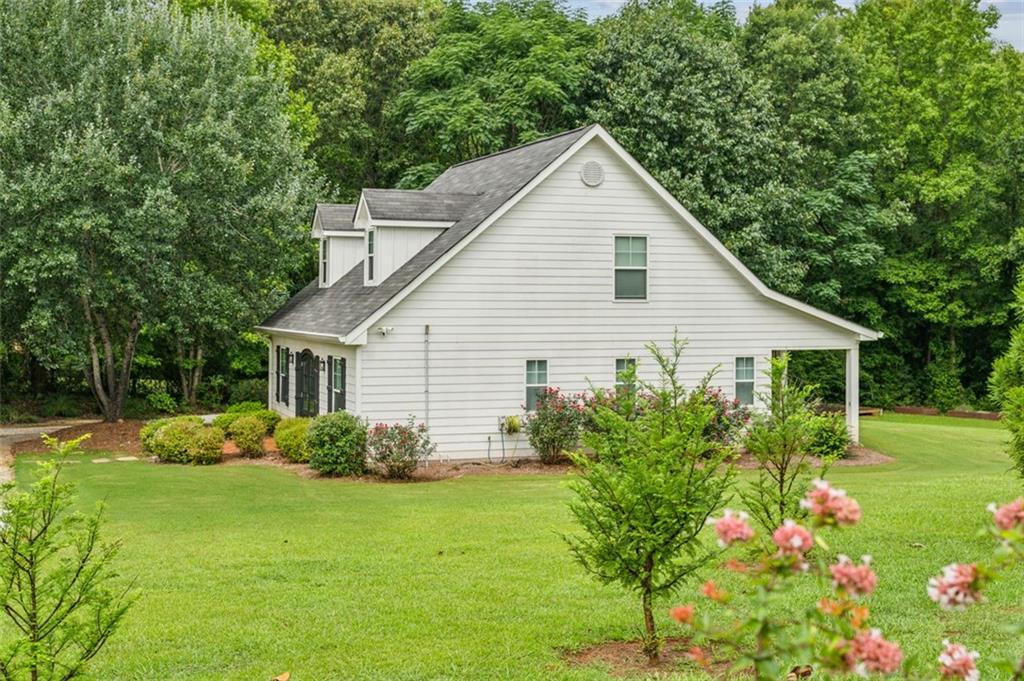 21 Willow Woods Road Social Circle, GA 30025 - Photo 5 of 49 a view of a house with garden and yard