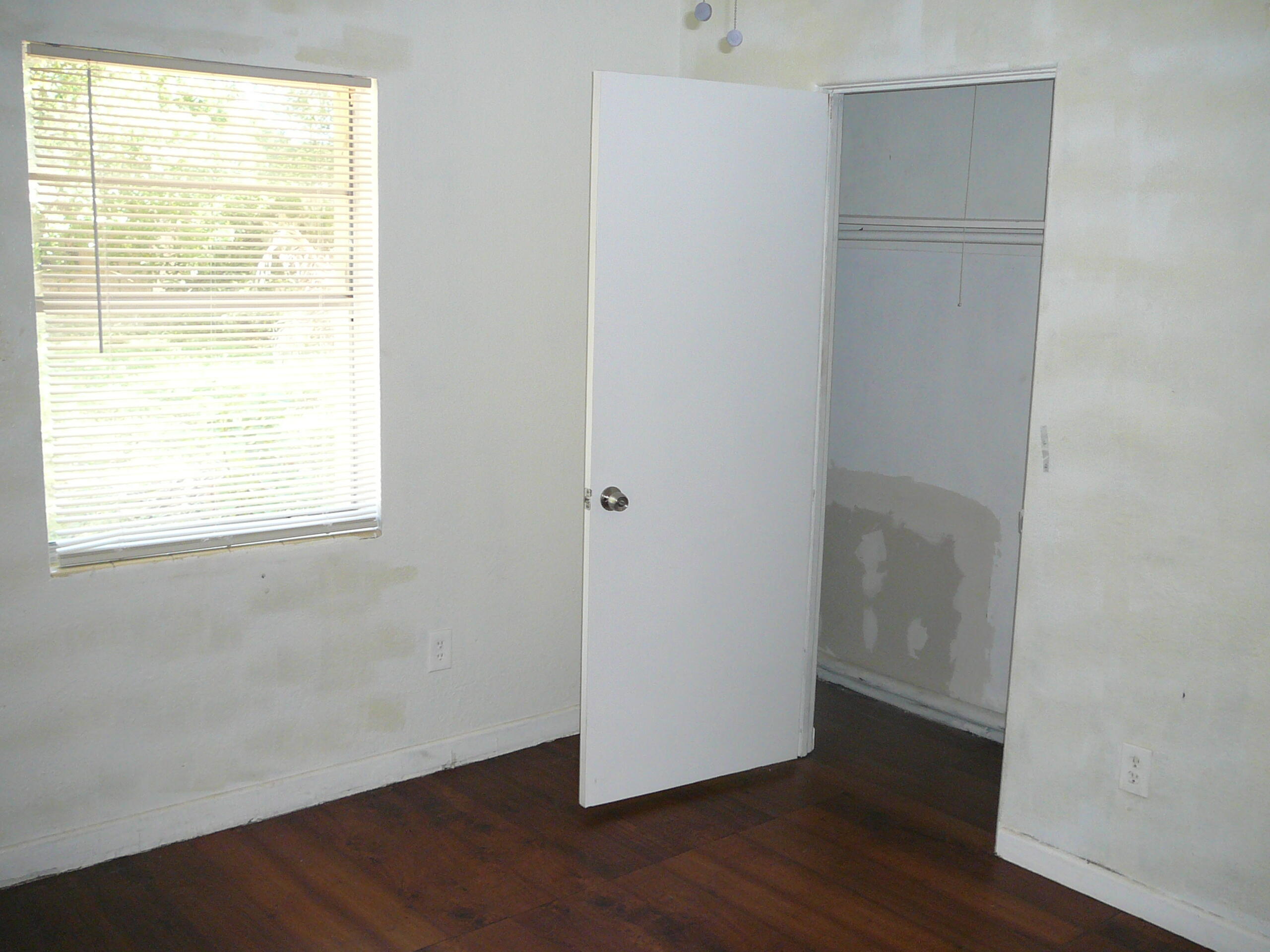 512 South 25th Street Fort Pierce, FL 34950 - Photo 14 of 17 a view of an empty room with wooden floor and a window