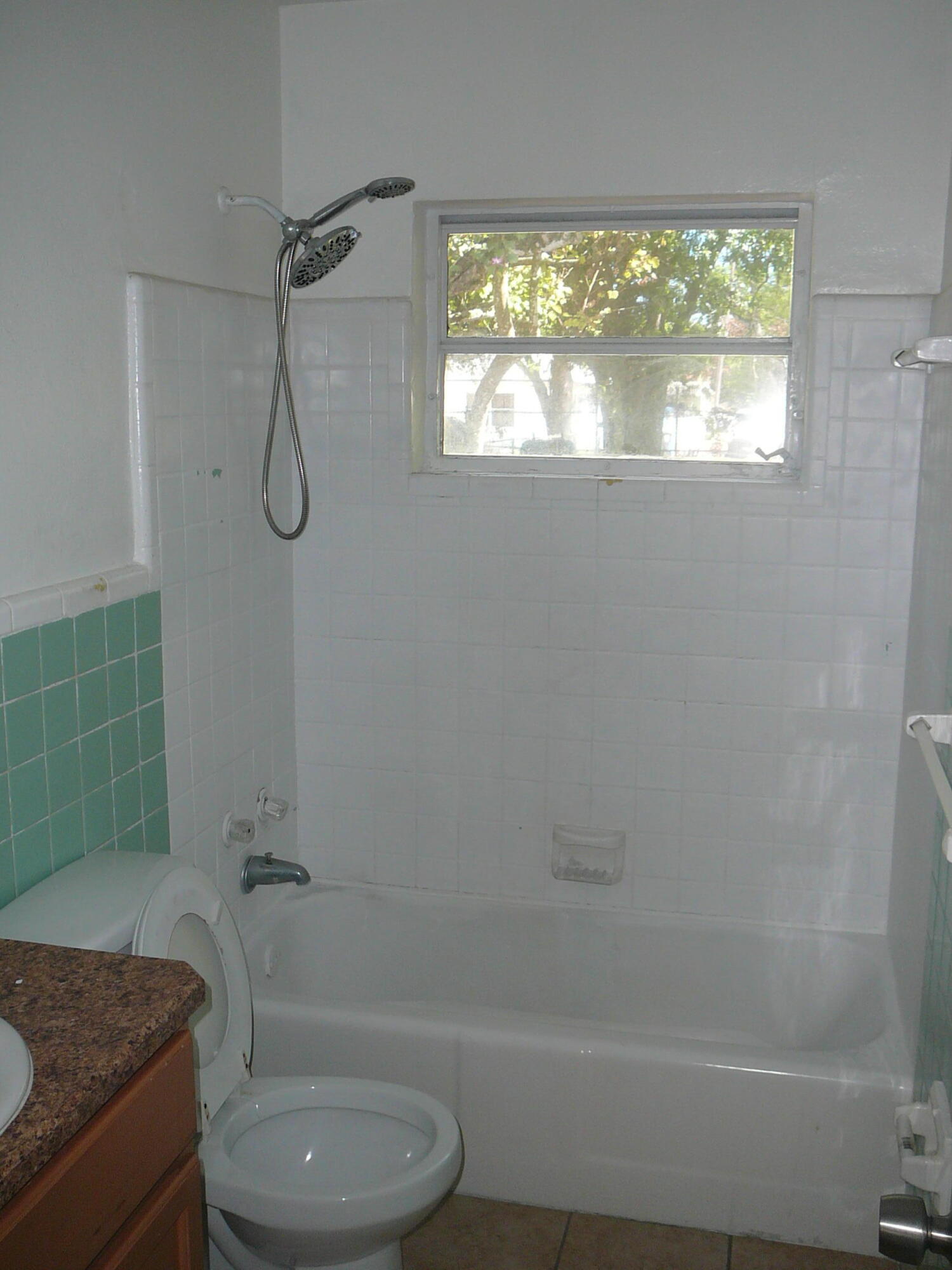512 South 25th Street Fort Pierce, FL 34950 - Photo 15 of 17 a bathroom with a granite countertop toilet and a shower