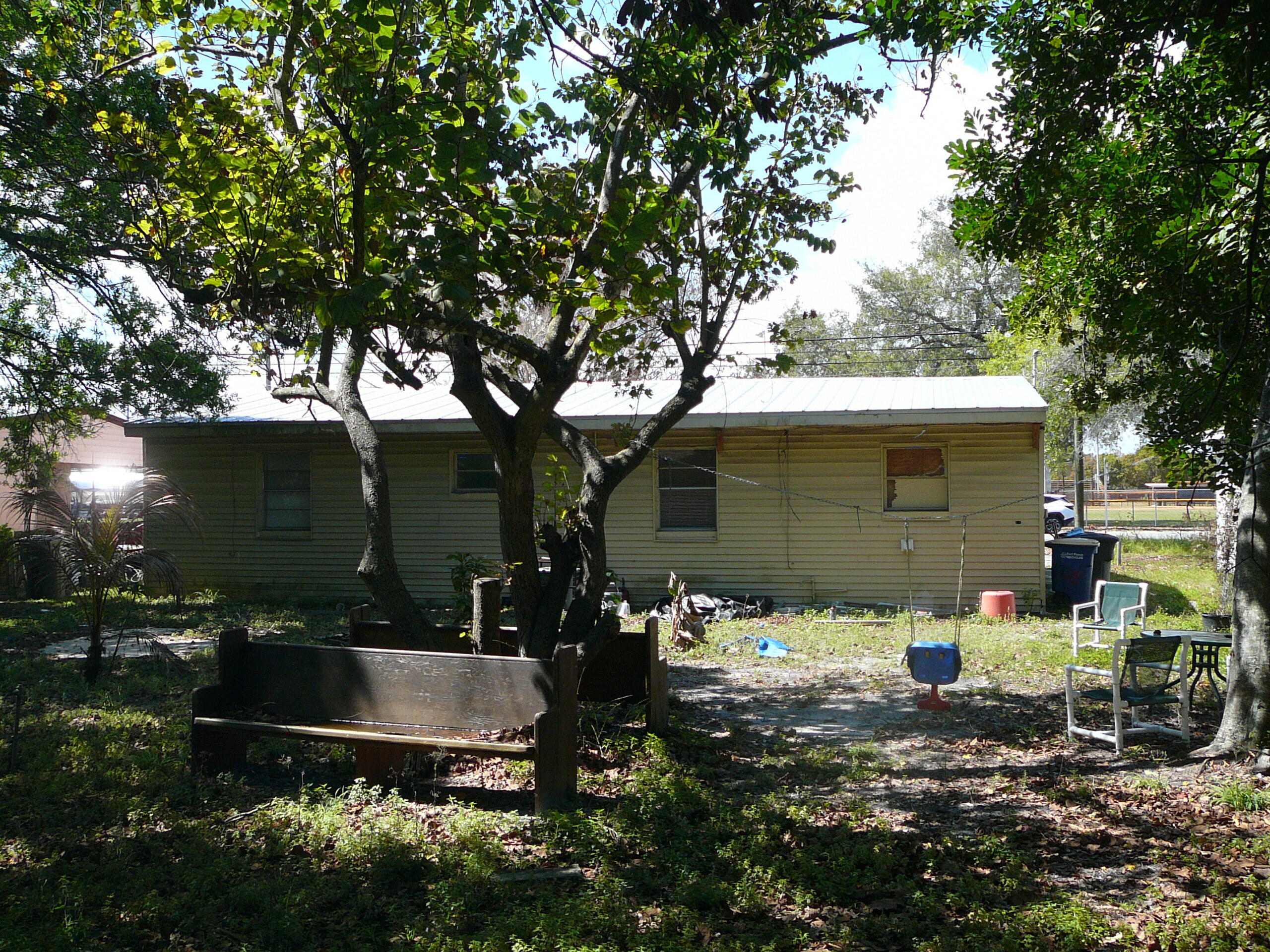 512 South 25th Street Fort Pierce, FL 34950 - Photo 5 of 17 a view of a couches under an umbrella