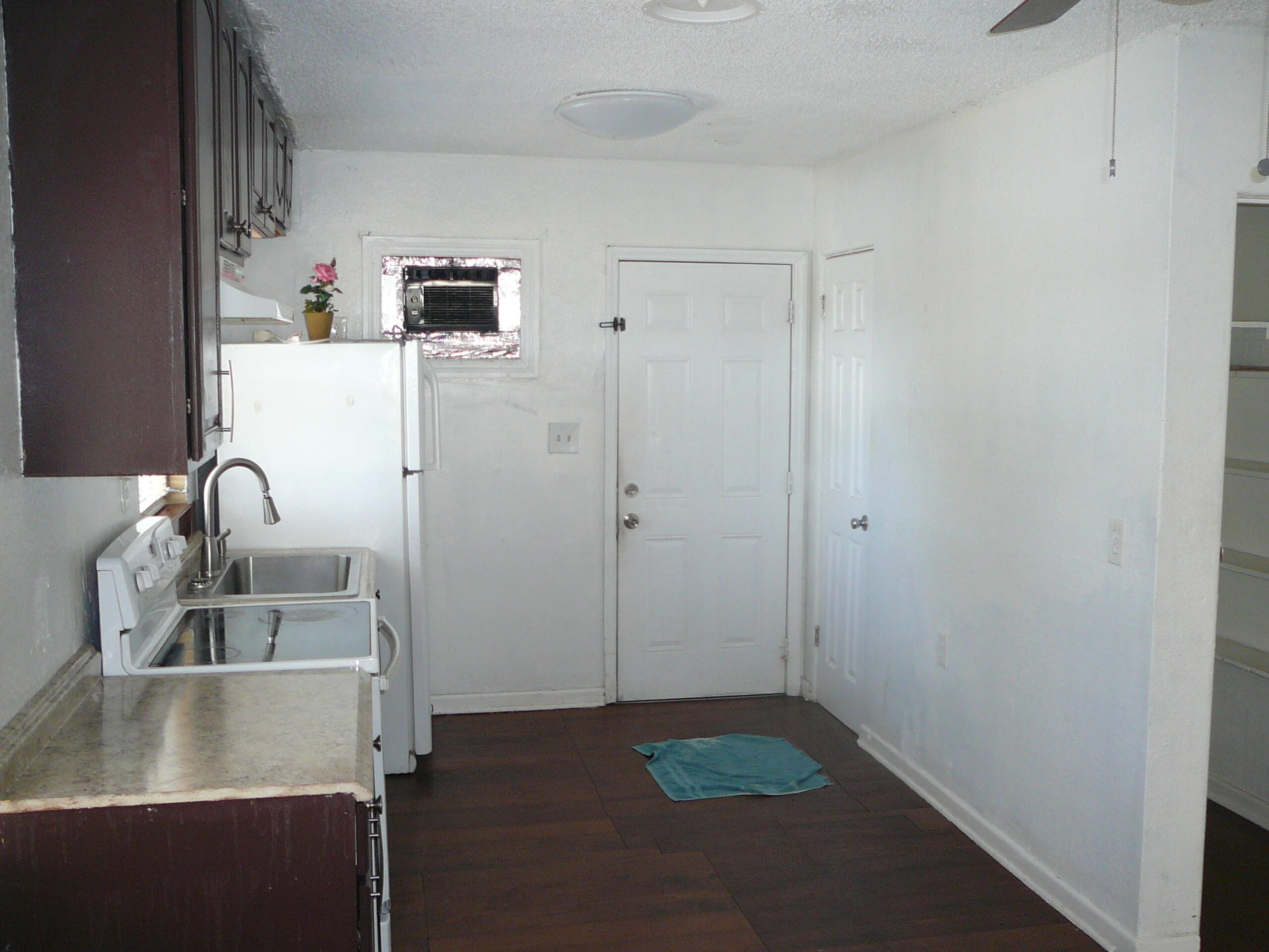 512 South 25th Street Fort Pierce, FL 34950 - Photo 9 of 17 a kitchen with a sink and refrigerator