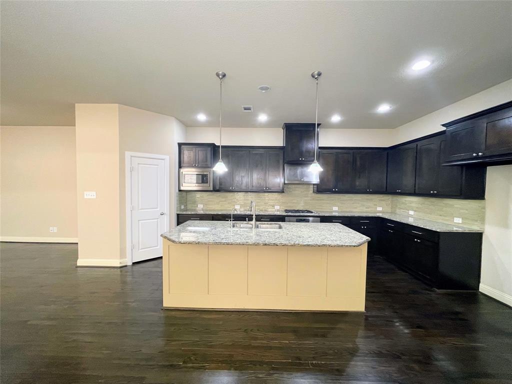 6622 DeLeon Street Irving, TX 75039 - Photo 9 of 32 a large kitchen with stainless steel appliances granite countertop a stove and a sink