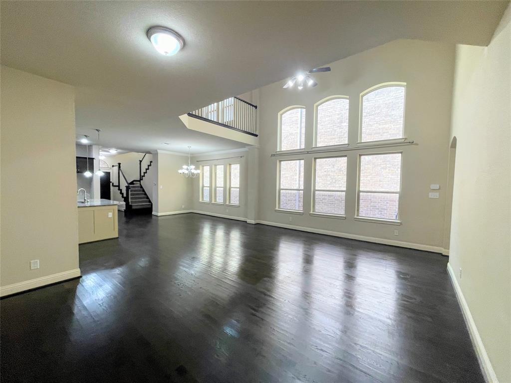 6622 DeLeon Street Irving, TX 75039 - Photo 13 of 32 a view of an empty room with wooden floor and a window