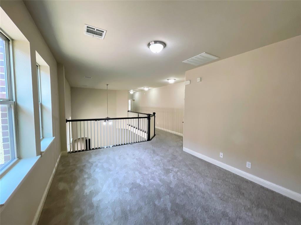 6622 DeLeon Street Irving, TX 75039 - Photo 18 of 32 a view of staircase with wooden floor and window