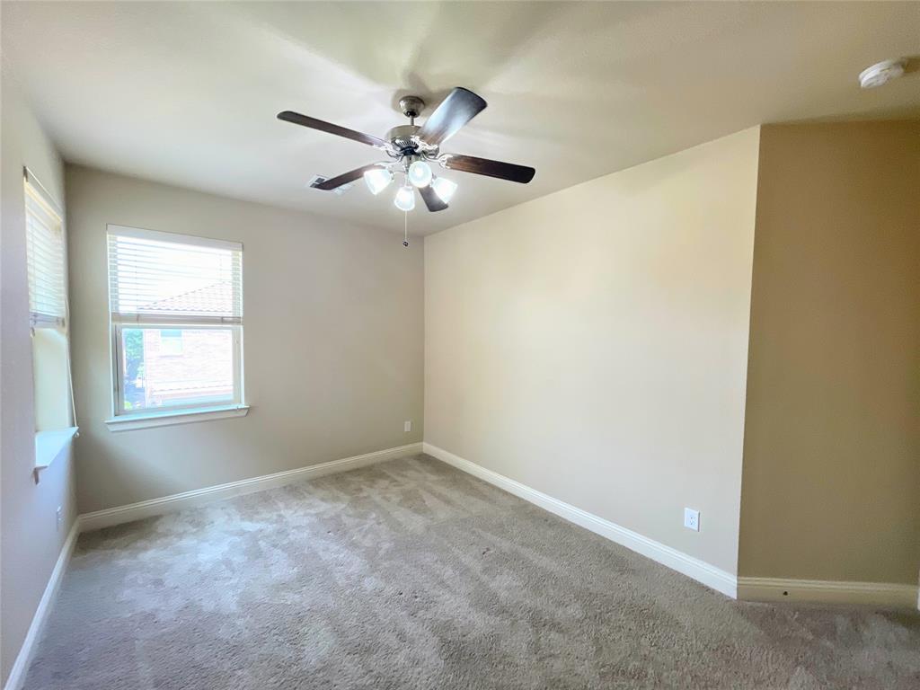 6622 DeLeon Street Irving, TX 75039 - Photo 22 of 32 an empty room with windows and fan