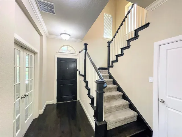 a view of entryway with wooden floor and stairs