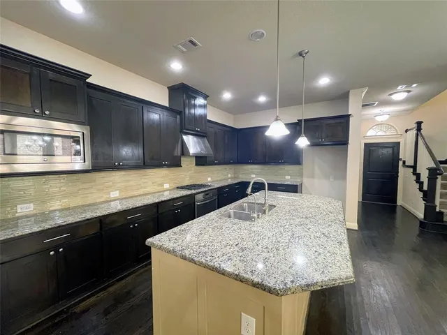 a bathroom with a granite countertop sink a large mirror and vanity