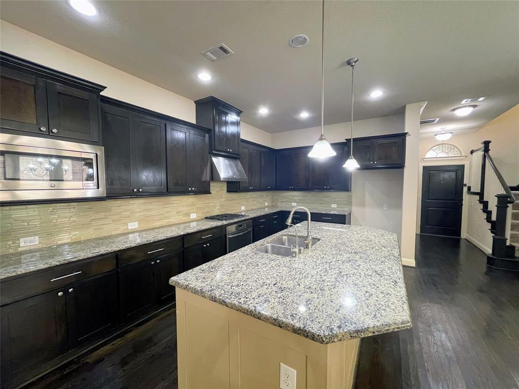 6622 DeLeon Street Irving, TX 75039 - Photo 8 of 32 a kitchen with stainless steel appliances granite countertop sink stove and refrigerator