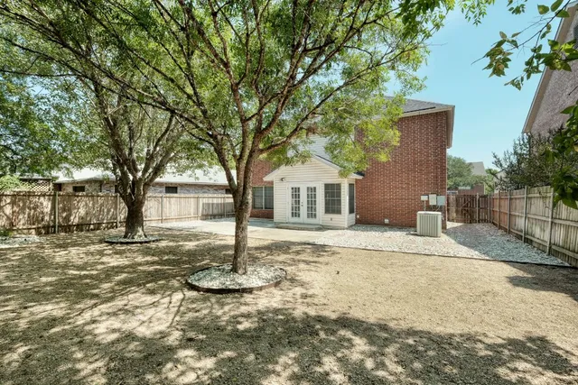 a white house that has a tree in front of it