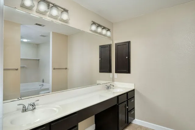 a bathroom with a sink double vanity and a mirror