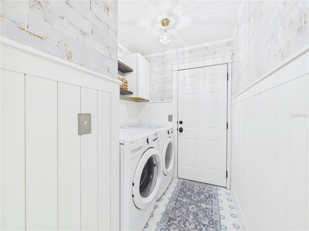 426 Long Cove Road Ormond Beach, FL 32174 - Photo 28 of 73 a view of a hallway with washer and dryer