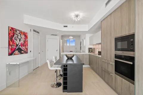 a living room with furniture dining area and a view of kitchen