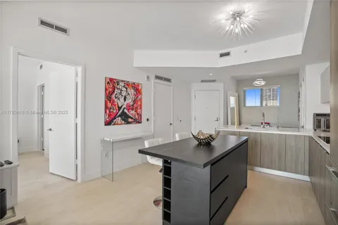 a bedroom with a large bed and a flat tv screen