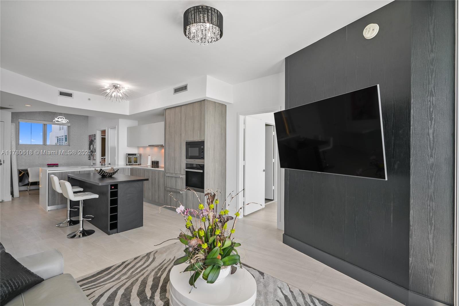 2900 Northeast 7th Avenue, Unit 1905 Miami, FL 33137 - Photo 19 of 82 a living room with furniture and a flat screen tv