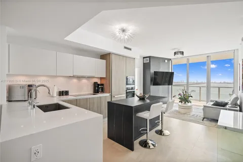 a kitchen with a sink a stove and cabinets
