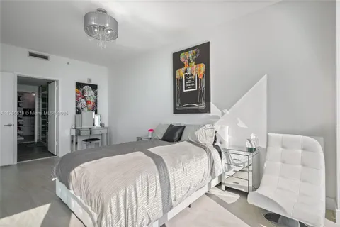 a bedroom with a bed and a television