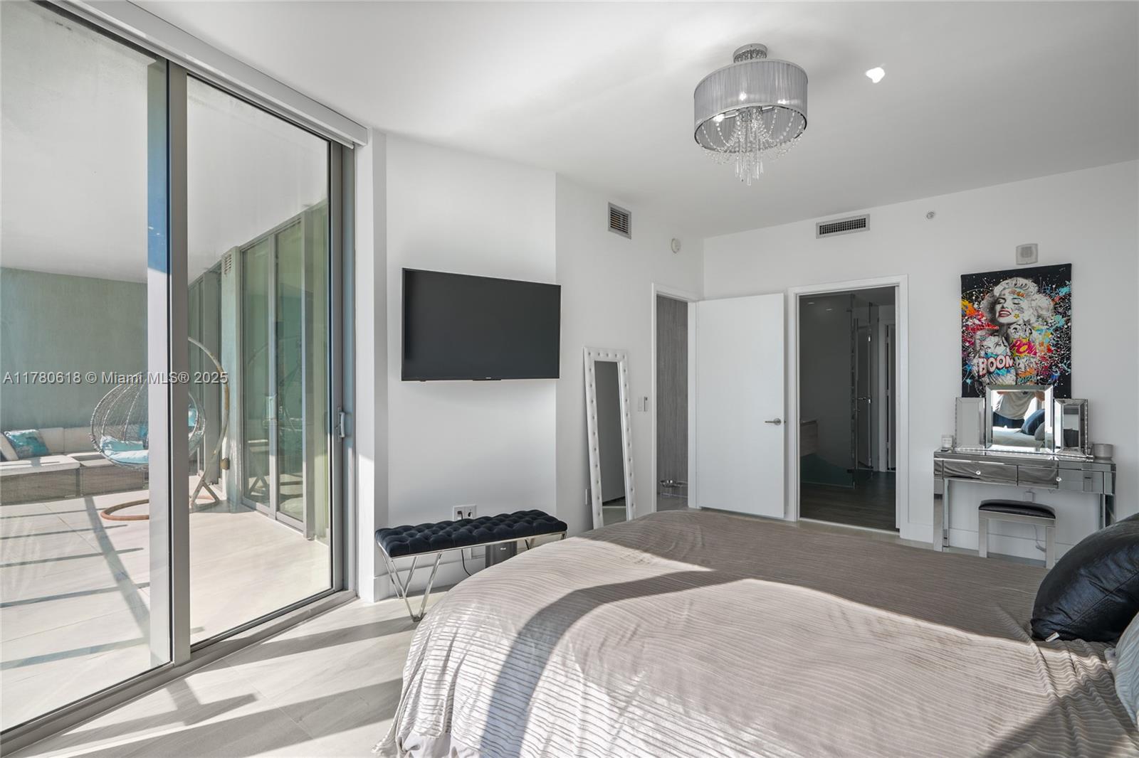 2900 Northeast 7th Avenue, Unit 1905 Miami, FL 33137 - Photo 26 of 82 a bedroom with a bed and glass door
