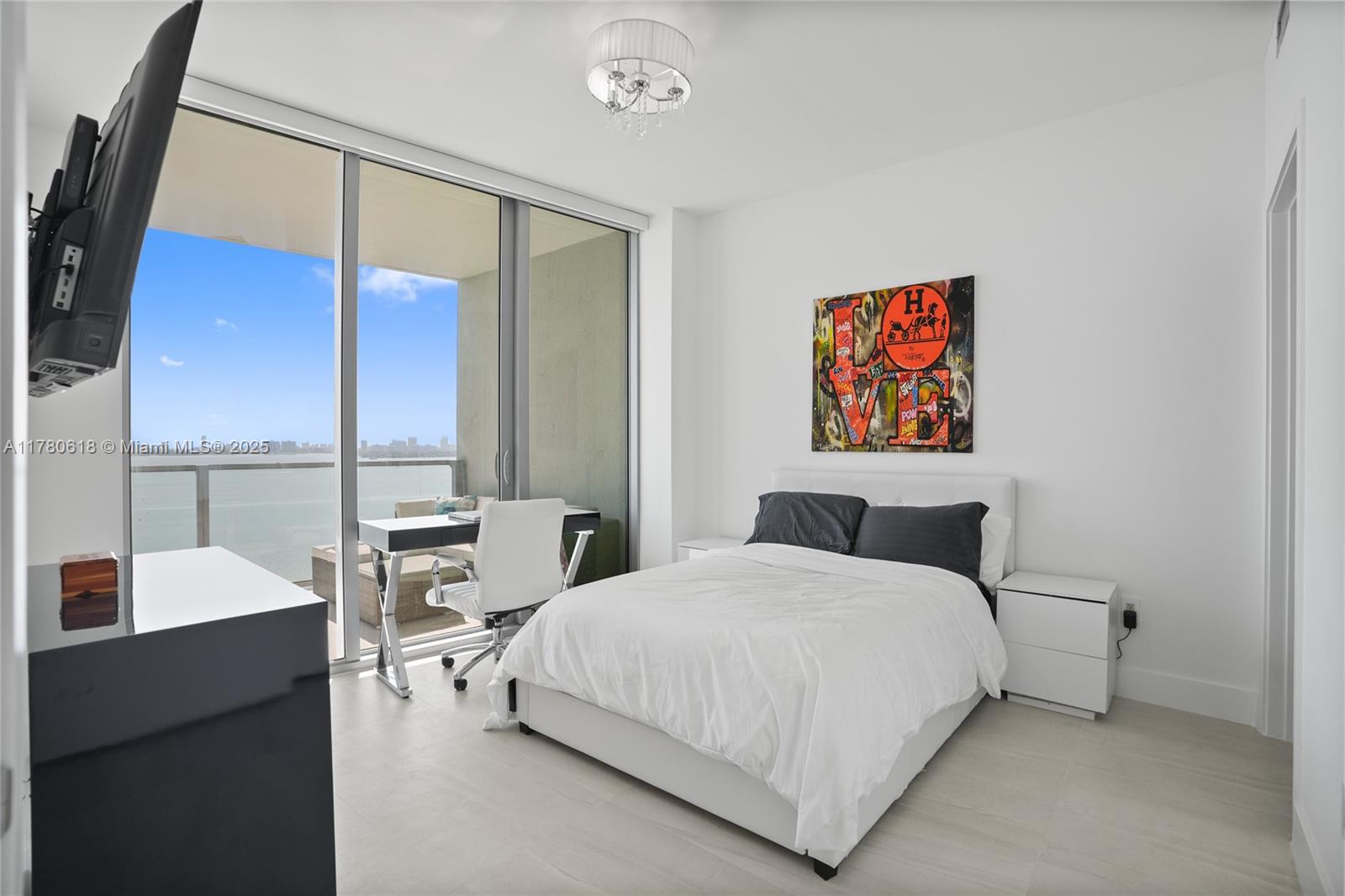 2900 Northeast 7th Avenue, Unit 1905 Miami, FL 33137 - Photo 32 of 82 a bedroom with a bed and a large mirror next to a window