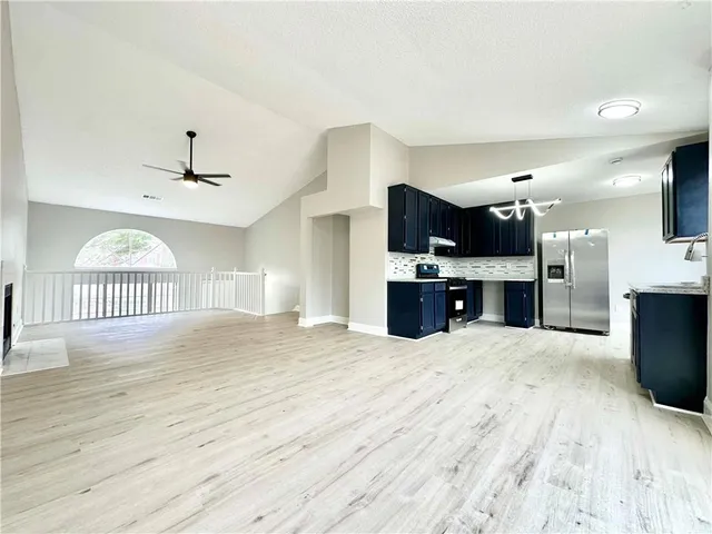 a view of a kitchen with a sink and a fireplace