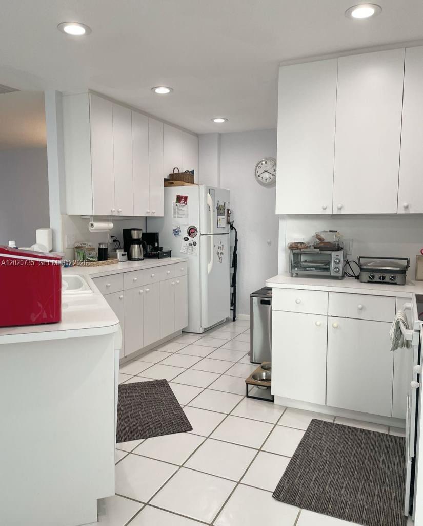17244 Balboa Point Way Boca Raton, FL 33487 - Photo 32 of 66 a kitchen with a sink a stove and refrigerator