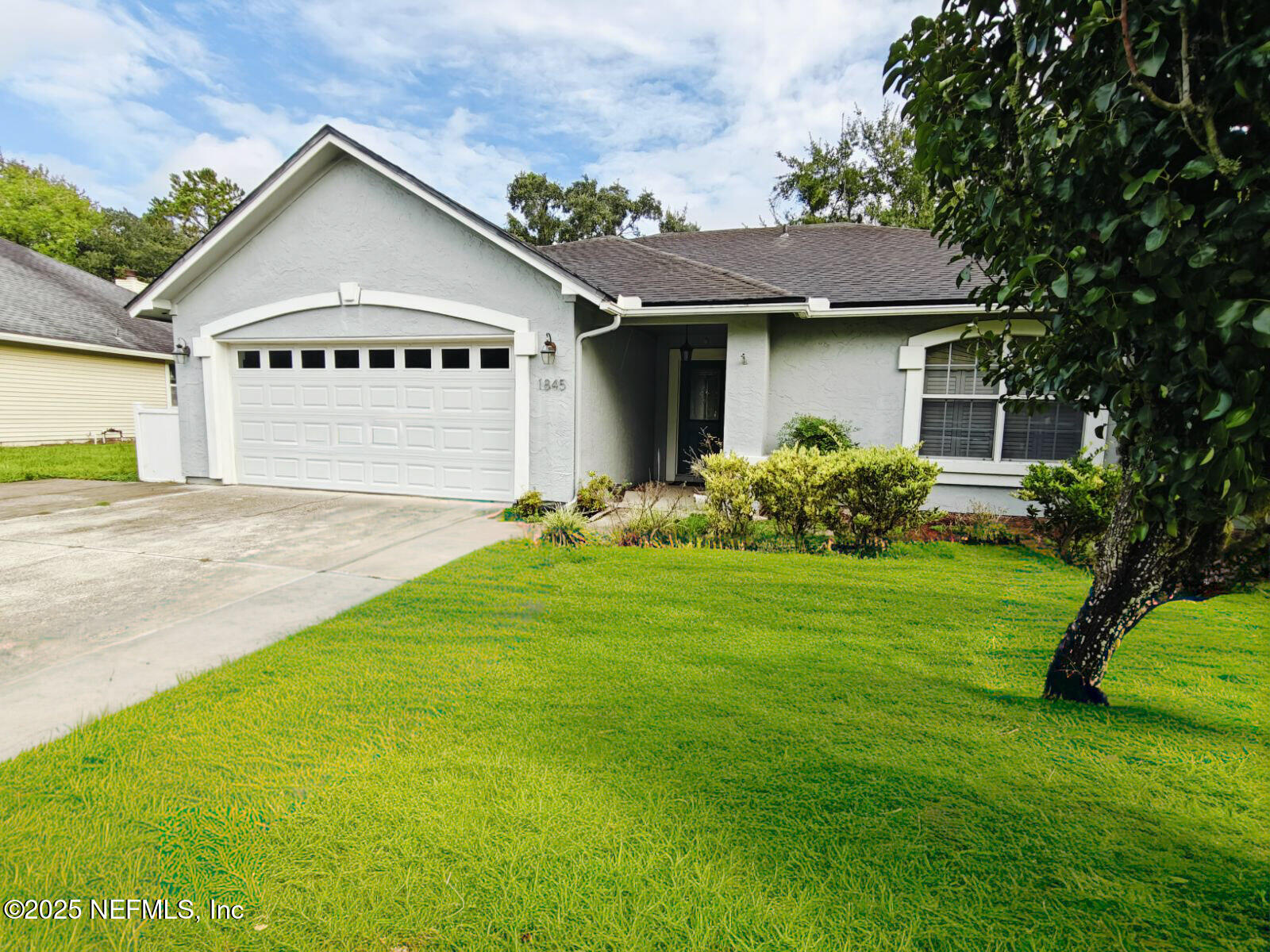 1845 Weston Circle Fleming Island, FL 32003 - Photo 1 of 36 a front view of a house with a garden and yard