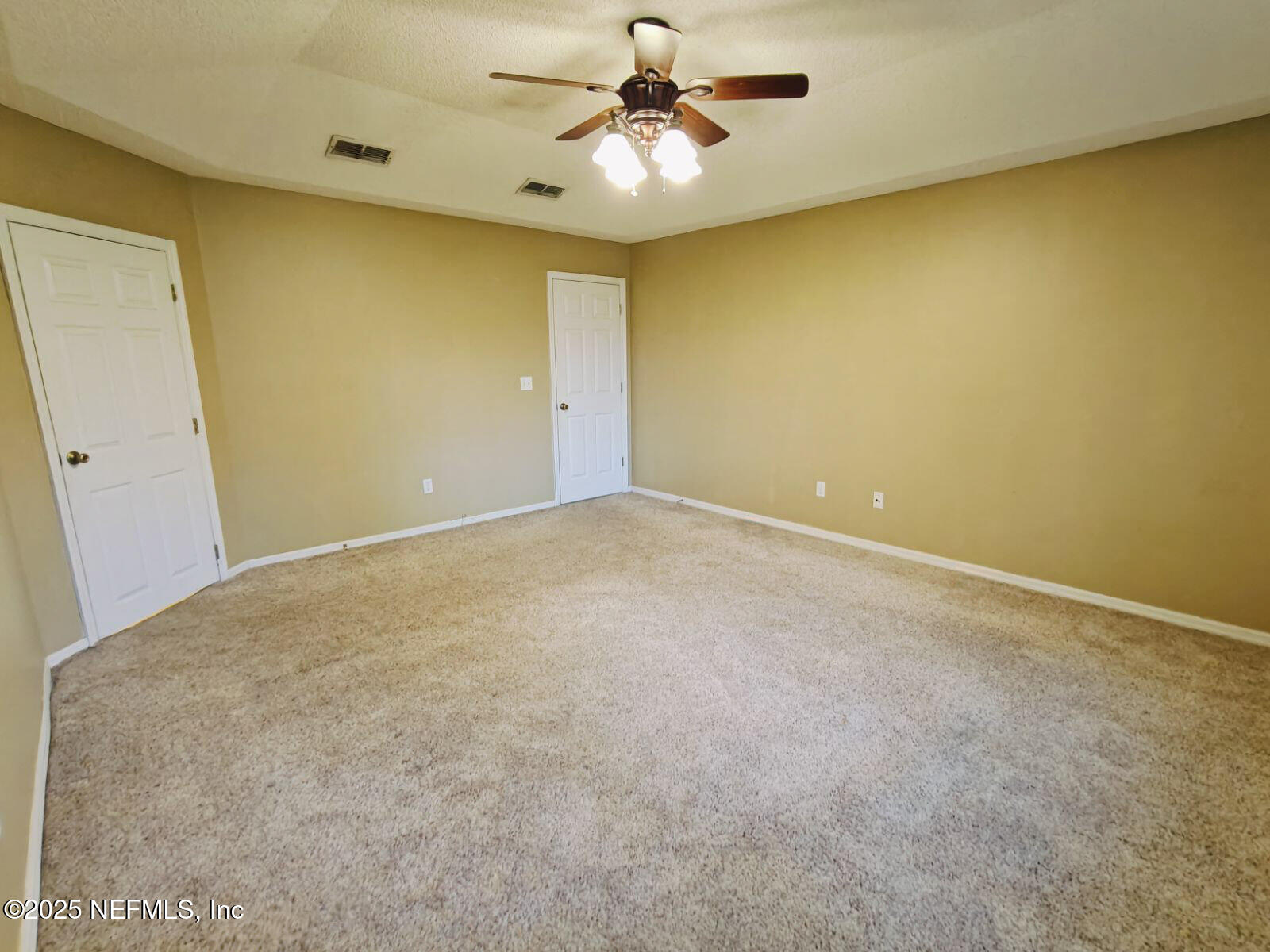 1845 Weston Circle Fleming Island, FL 32003 - Photo 16 of 36 an empty room with a ceiling fan and a window