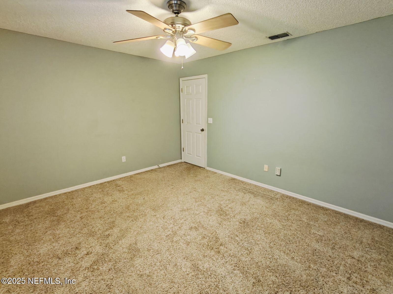 1845 Weston Circle Fleming Island, FL 32003 - Photo 24 of 36 an empty room with a fan & a window