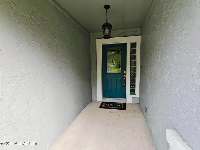 a living room with a window and a ceiling fan
