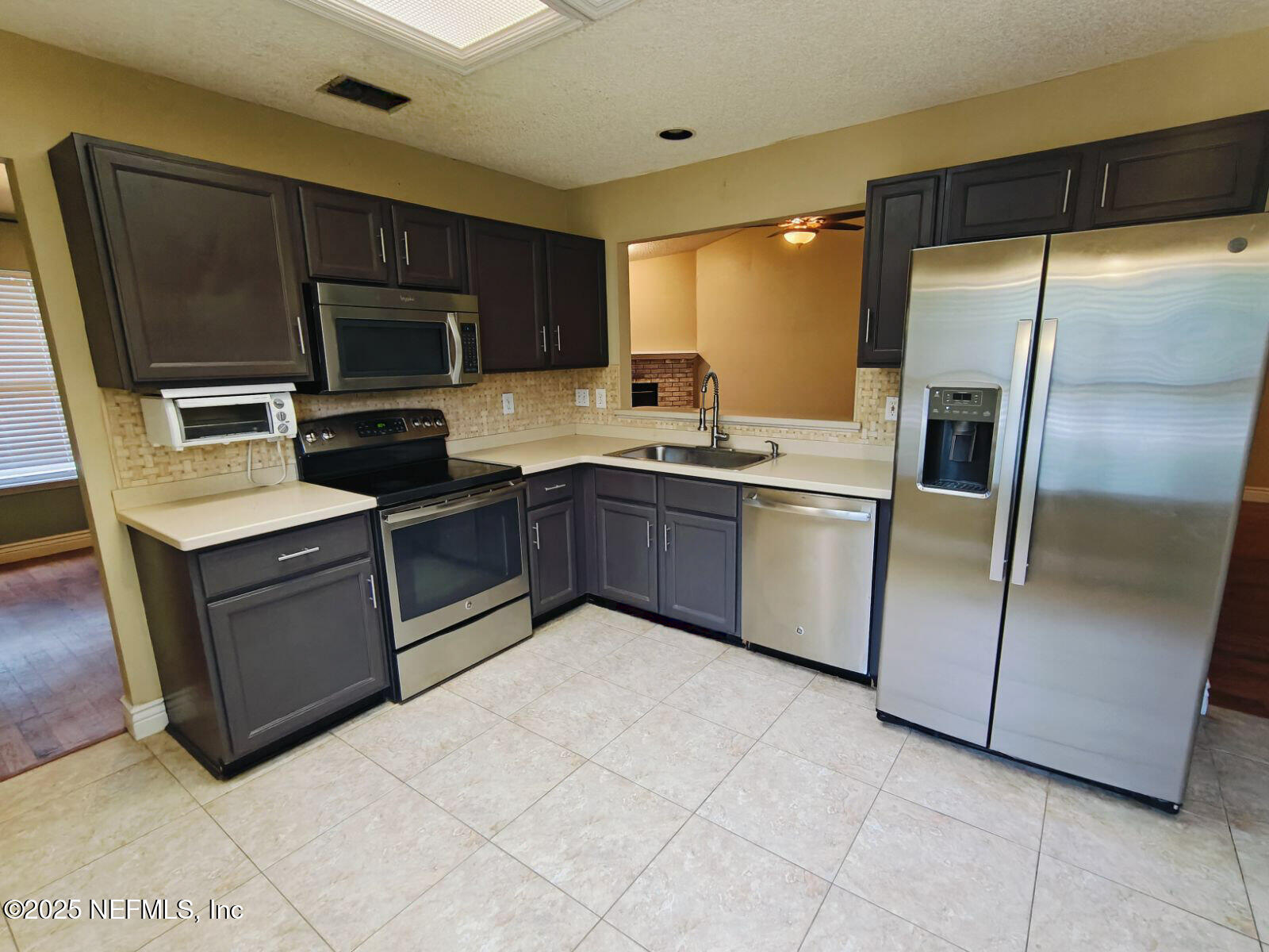 1845 Weston Circle Fleming Island, FL 32003 - Photo 9 of 36 a kitchen with stainless steel appliances granite countertop a refrigerator a sink a stove top oven and dishwasher