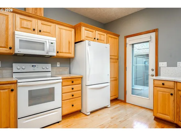 a kitchen with stainless steel appliances a stove microwave and refrigerator