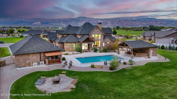 an aerial view of a house with a garden and a yard