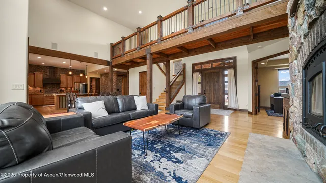 a living room with furniture wooden floor and a flat screen tv