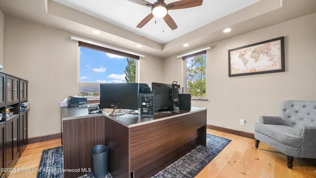 a work room with furniture and a flat screen tv