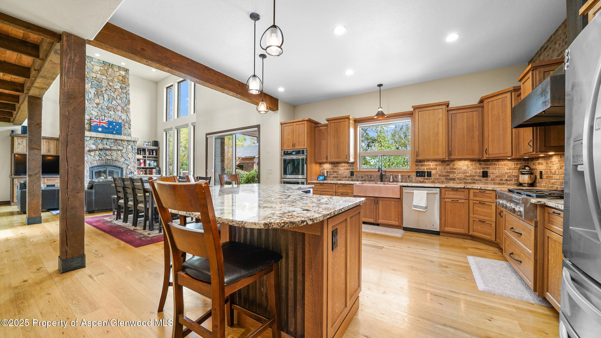 1980 Alabama Boy Court Fruita, CO 81521 - Photo 20 of 52 a open kitchen with stainless steel appliances kitchen island granite countertop a table chairs and a refrigerator