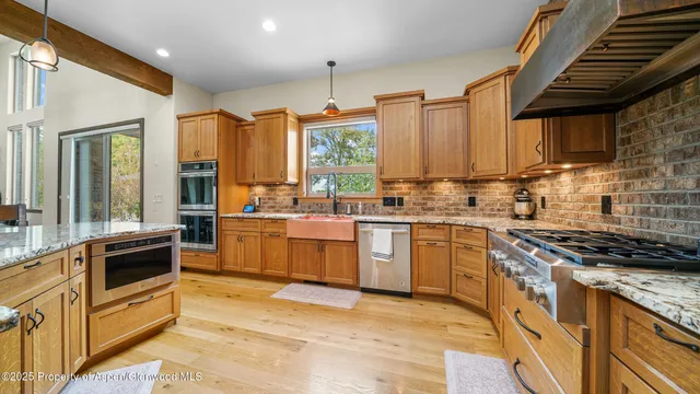a kitchen with a stove a sink and a refrigerator