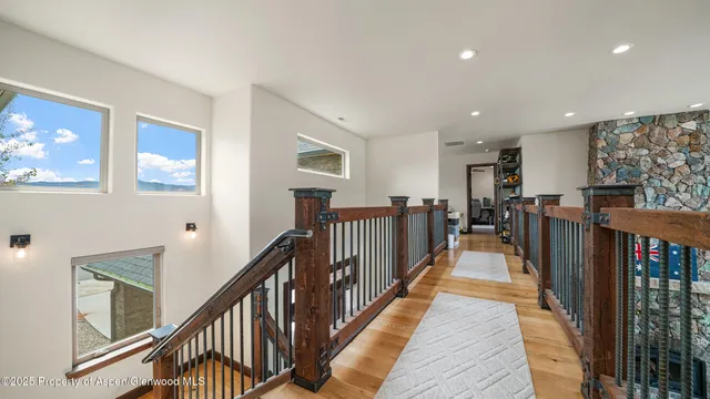 a spacious bedroom with a bed and a chandelier