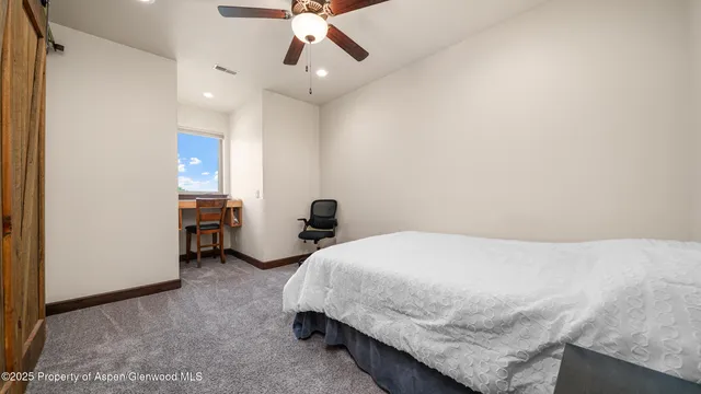 a bathroom with a granite countertop sink a mirror and shower