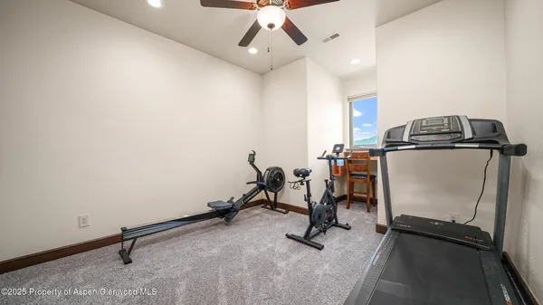 a living room with furniture a flat screen tv and a table