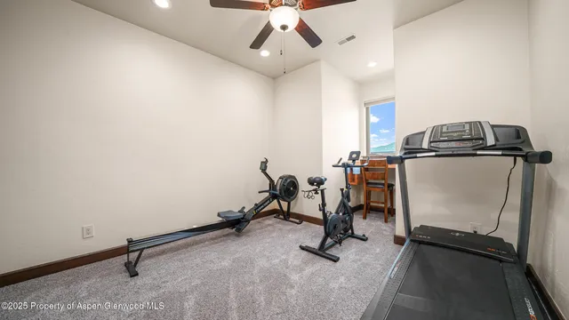 a living room with furniture a flat screen tv and a table